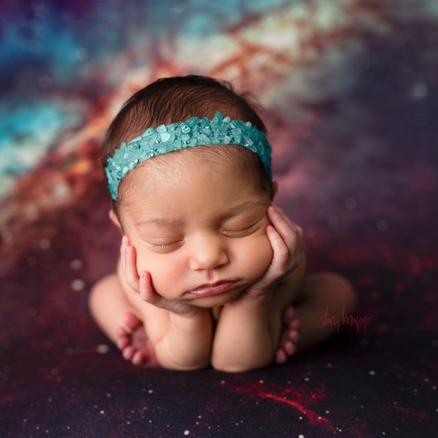 Maine newborn baby girl in froggy pose on a space backdrop by photographer Stacy Knapp Photography