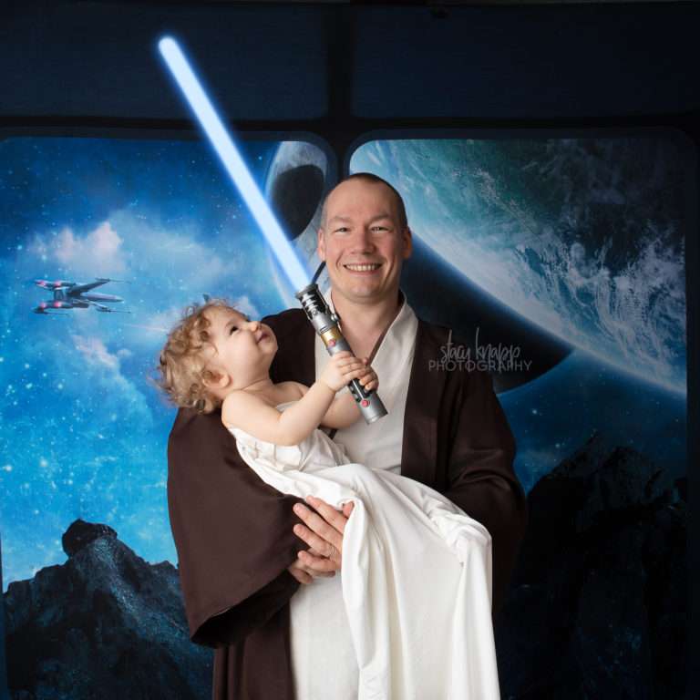 Star Wars photo of father and daughter with a lightsaber