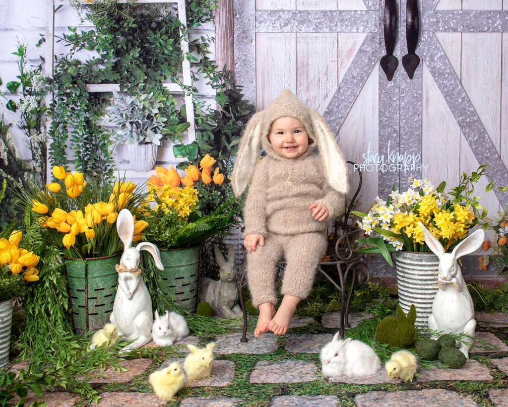 Spring mini session photograph of a baby girl in bunny outfit