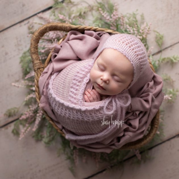 Maine newborn baby girl in pink outfit in a basket by photographer Stacy Knapp Photography
