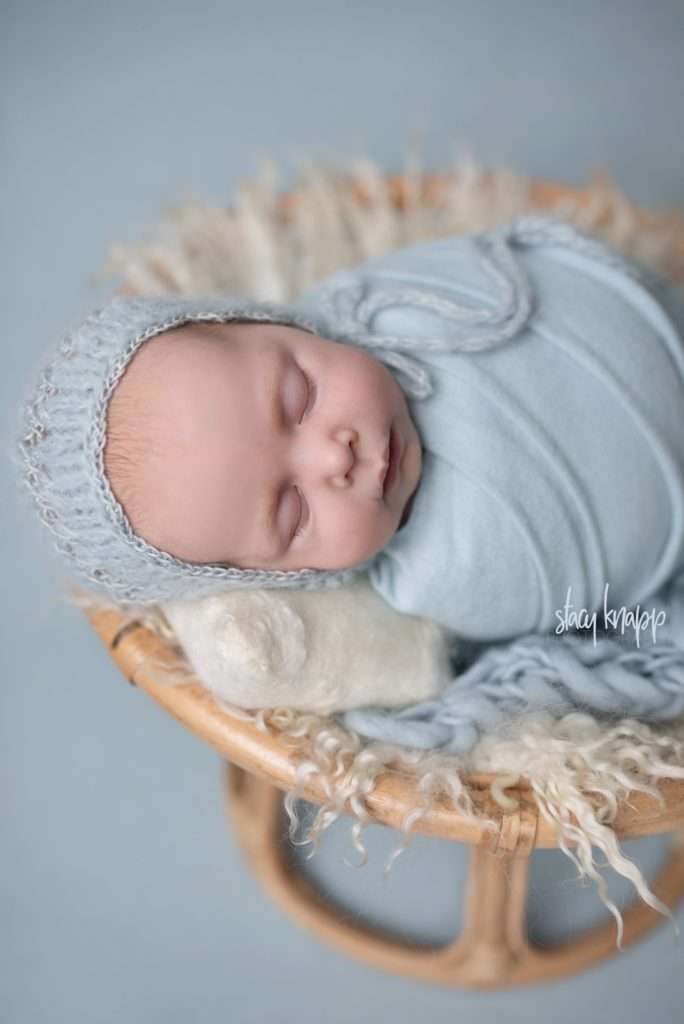 Newborn baby girl in blue bonnet