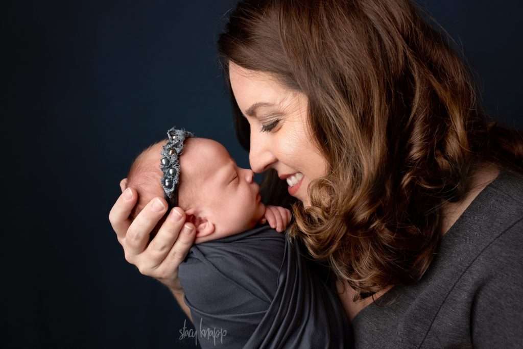 mom and newborn baby girl nose to nose