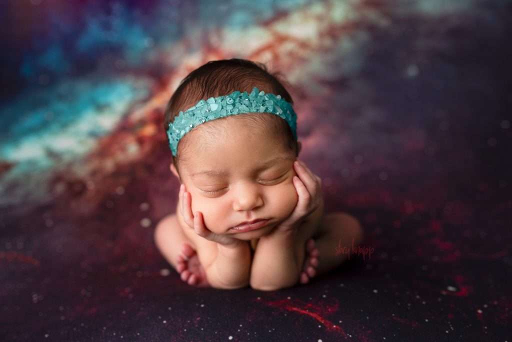 Maine newborn baby girl in froggy pose on a space backdrop by photographer Stacy Knapp Photography