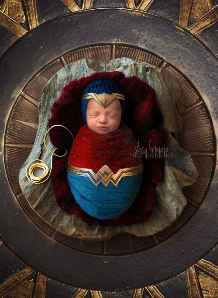 photo of newborn baby girl wrapped as Wonder Woman
