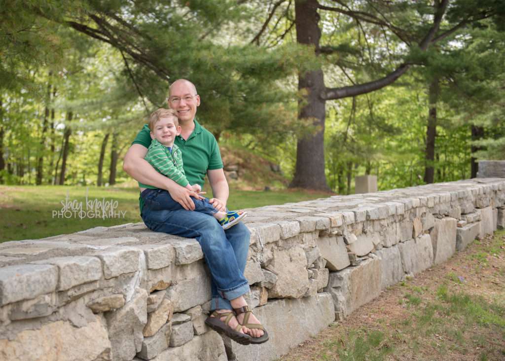 Father and son photographed on a stone wall in Augusta, Maine