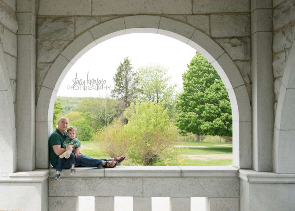Father and son photographed on a stone wall in Augusta, Maine