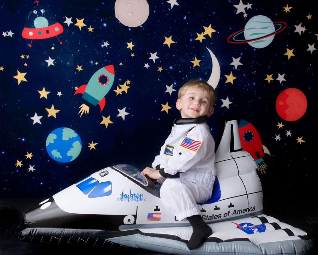Toddler boy photographed riding space ship