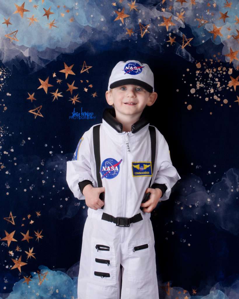 Toddler boy photographed wearing space suit