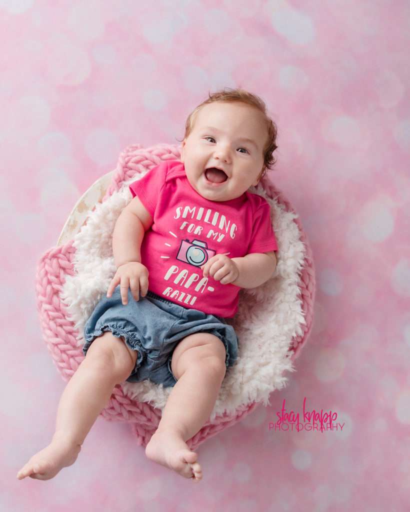 Baby girl photographed wearing paparazzi onesie