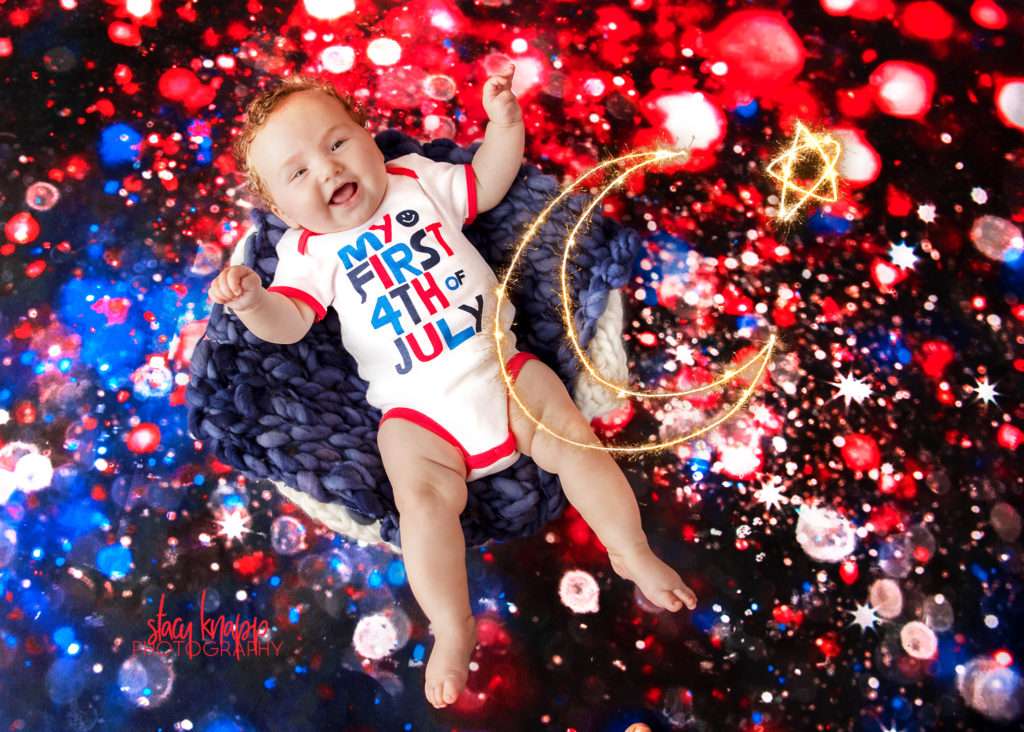 Baby girl photographed on Fourth of July backdrop