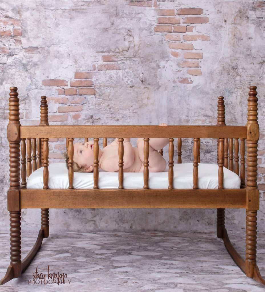 Baby girl photographed in crib