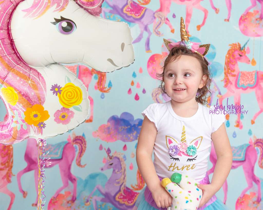 Three-year-old girl birthday photograph with unicorns