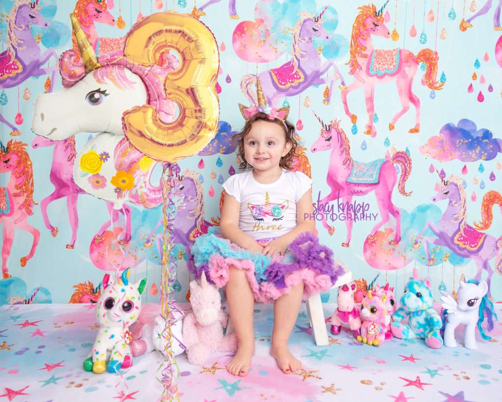 Three-year-old girl birthday photograph with unicorns