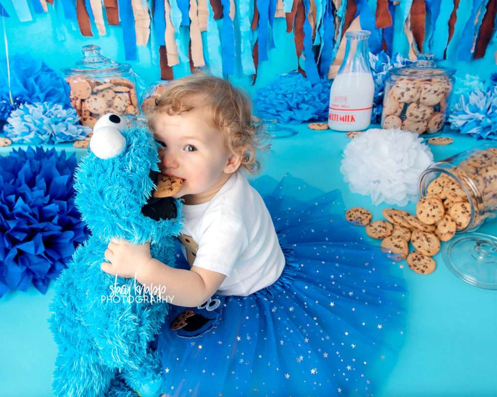 Cookie monster cake smash photograph with one-year old baby girl