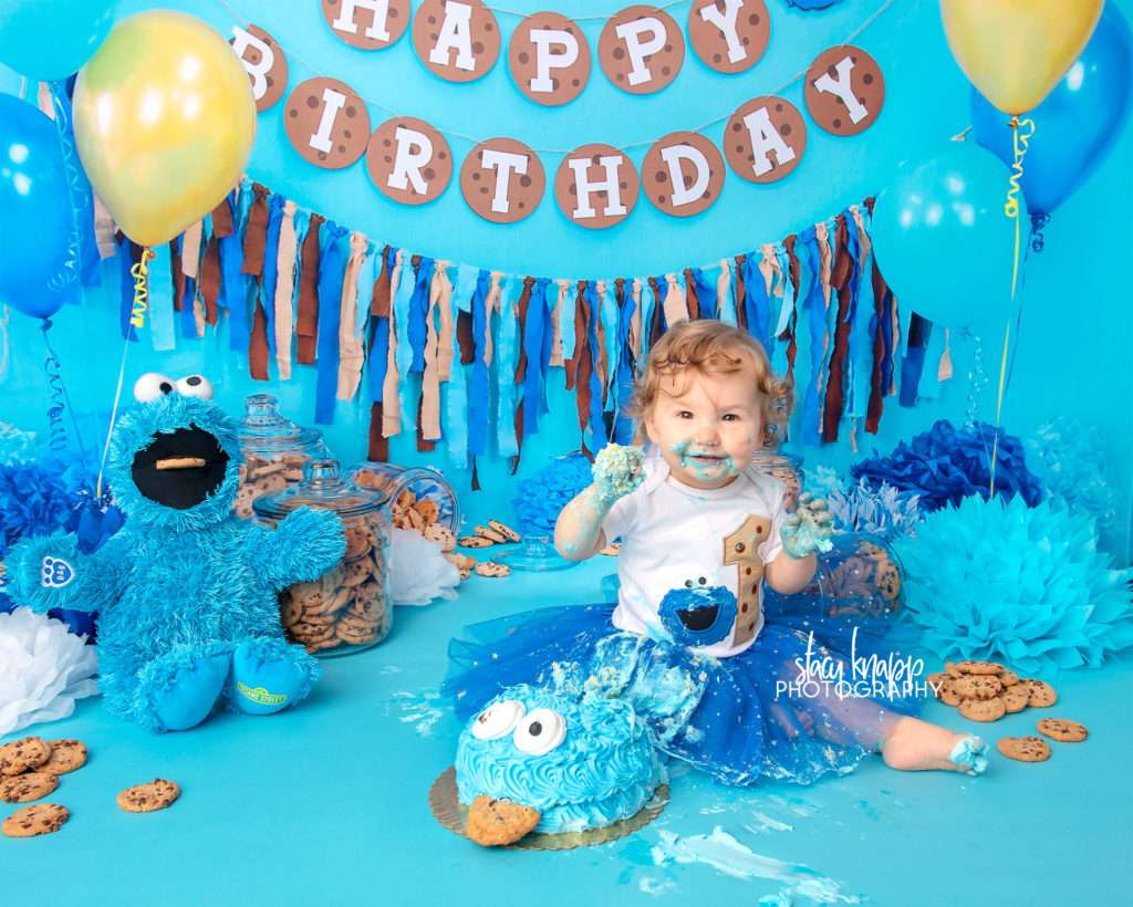Cookie monster cake smash photograph with one-year old baby girl