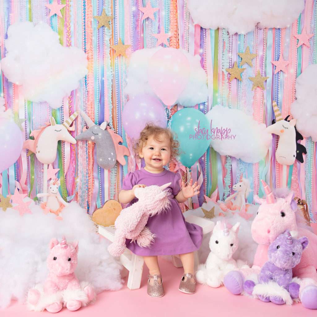 Baby girl photograph on a unicorn backdrop