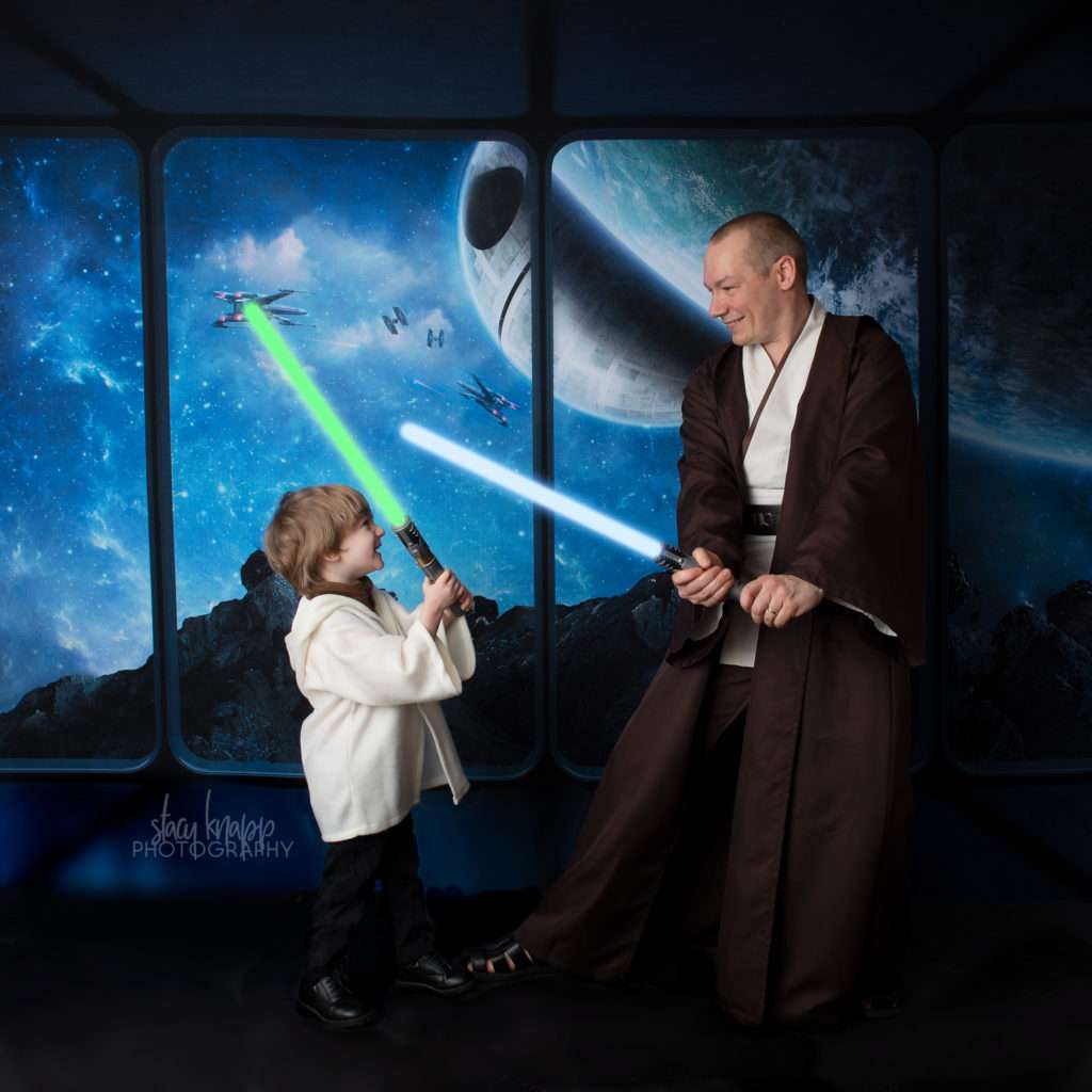 Star Wars photo of father and son having a lightsaber fight