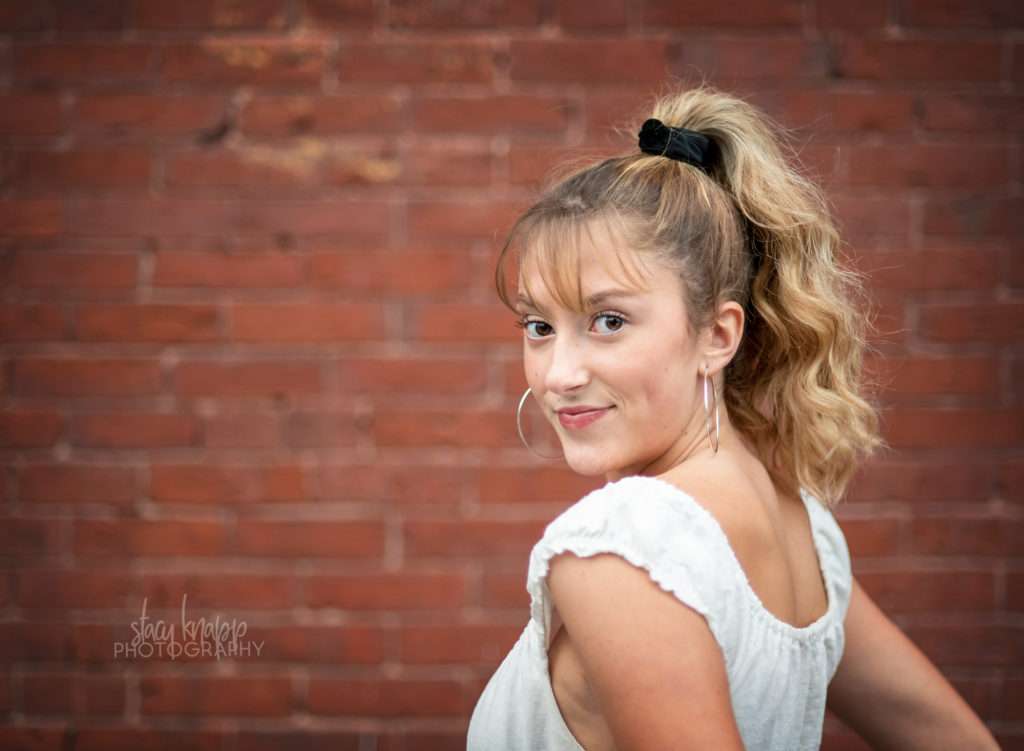 Senior girl near brick