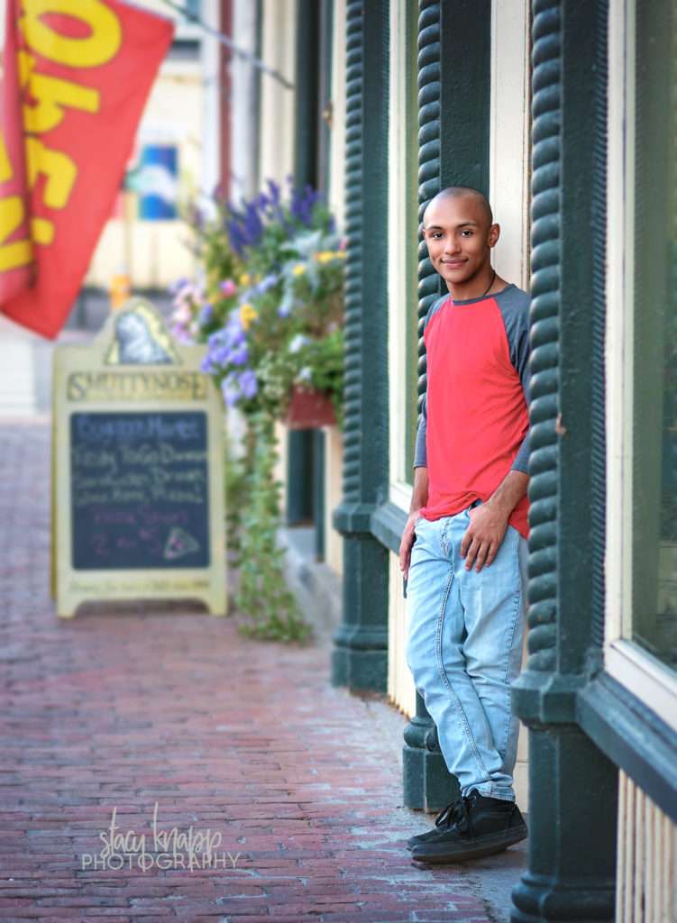 Senior leaning against door