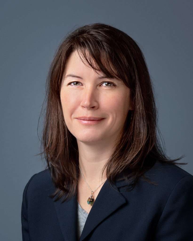 Woman in navy suit headshot by photographer Stacy Knapp Photography