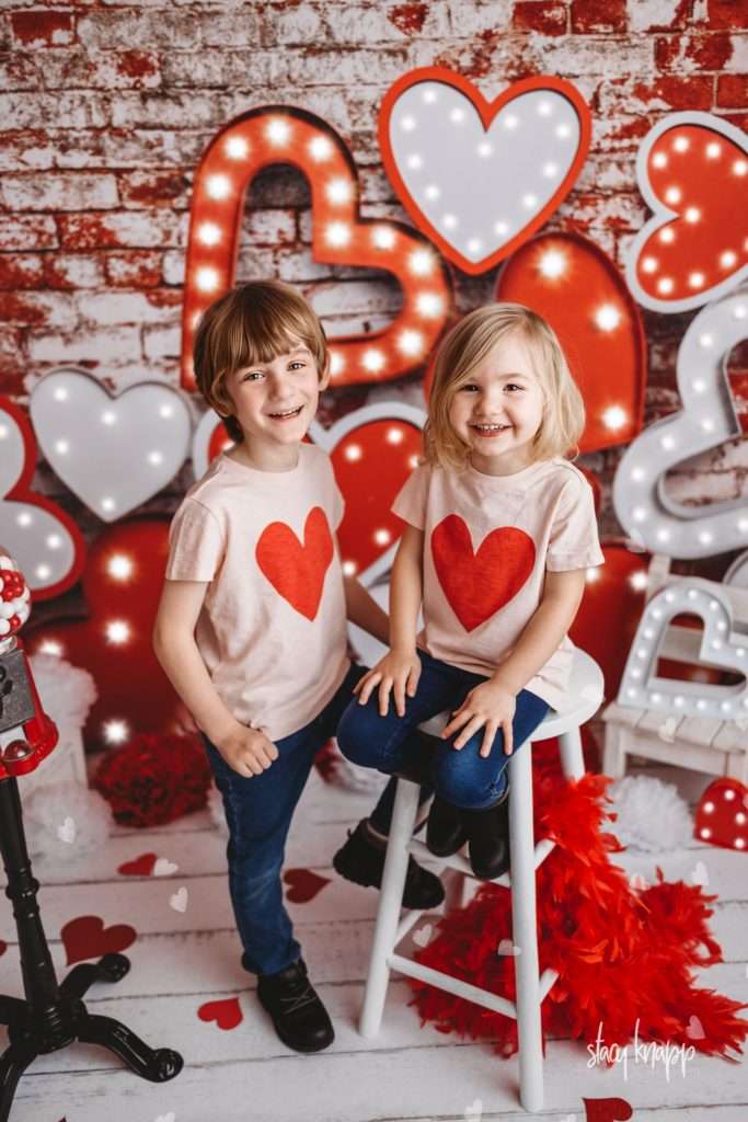 Brother and sister celebrating valentines day at Stacy Knapp Photography wearing heart t-shirts