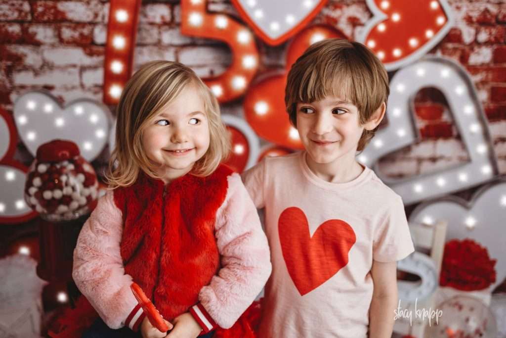 Brother and sister celebrating valentines day at Stacy Knapp Photography looking at each other