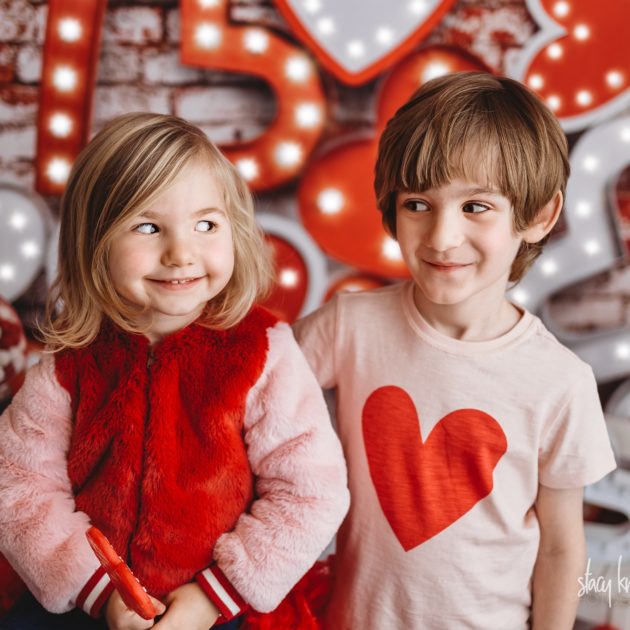 Brother and sister celebrating valentines day at Stacy Knapp Photography looking at each other
