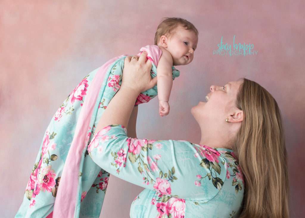 Mommy and me photo session with baby girl on pink backdrop