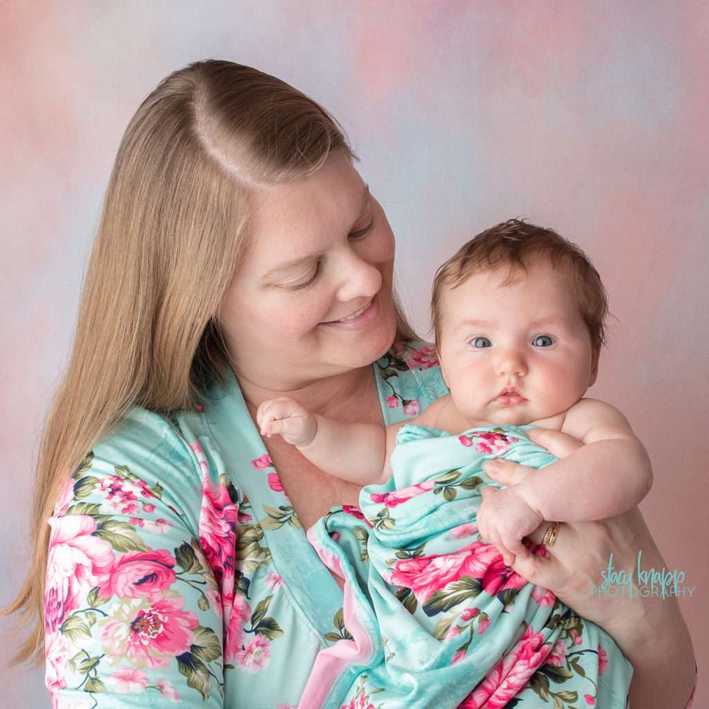 Mommy and me photo session with baby girl on pink backdrop