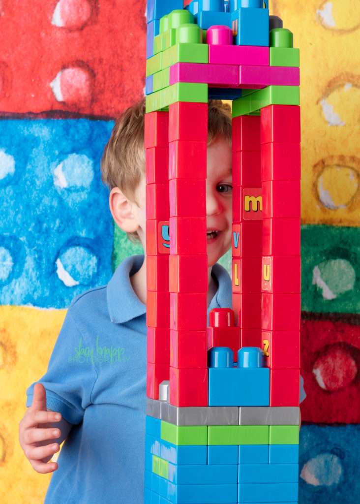 Preschool boy on lego backdrop
