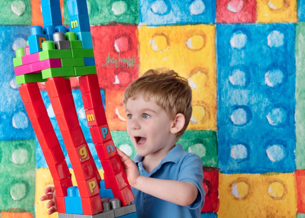 Preschool boy on lego backdrop