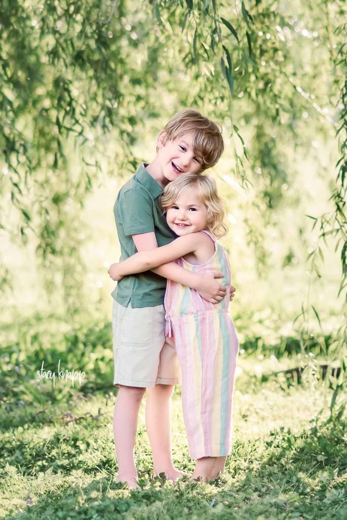 sibling portrait photo of little boy and little girl under a willow tree by child and family photographer Stacy Knapp Photography