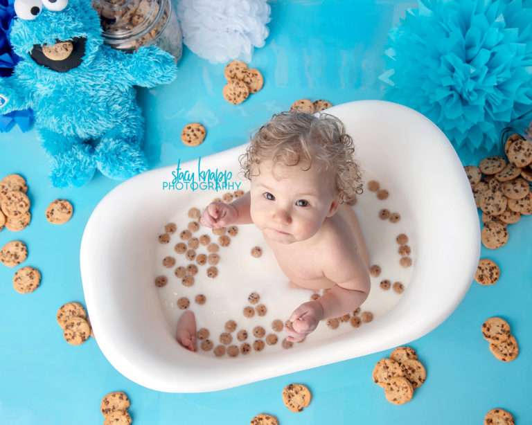 Baby girl in cookie monster bath during a splash session