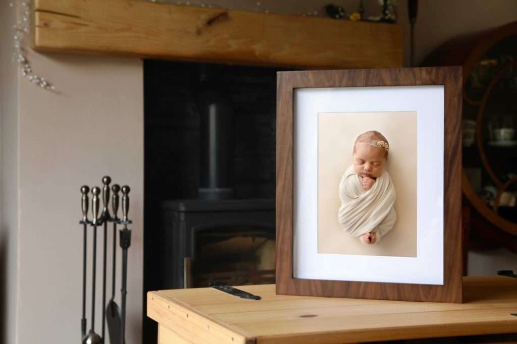 Newborn baby portrait in a walnut keepsake box
