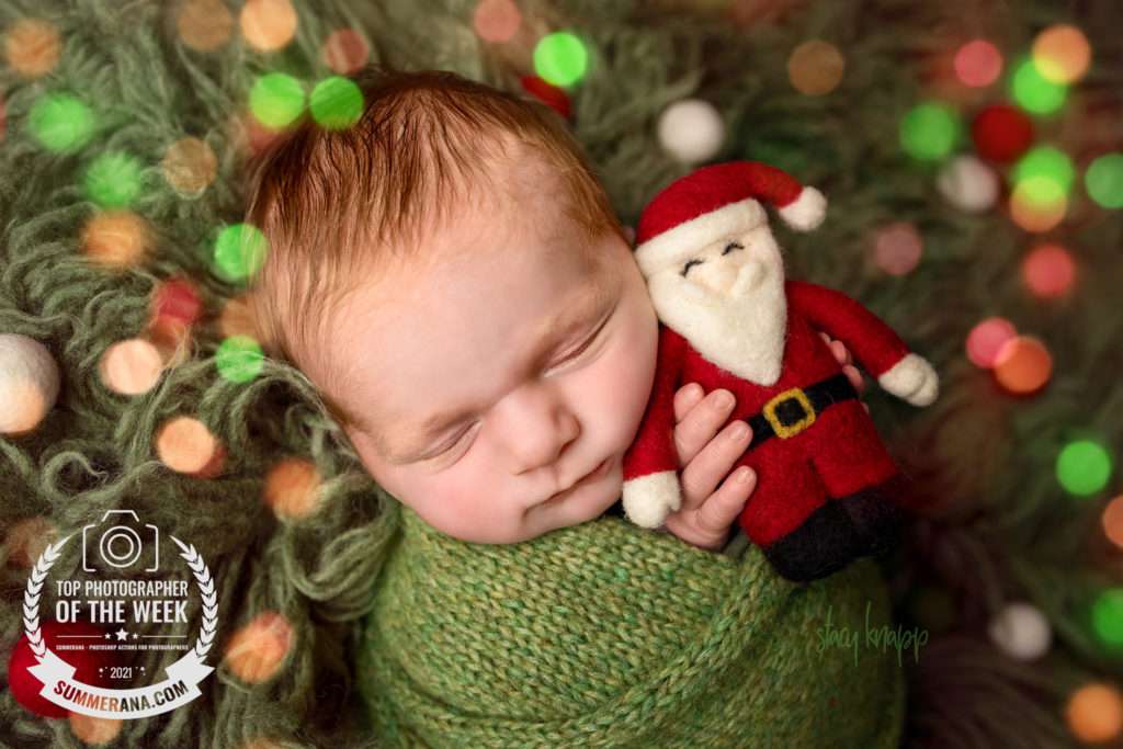 Newborn photo of baby boy with Christmas lights
