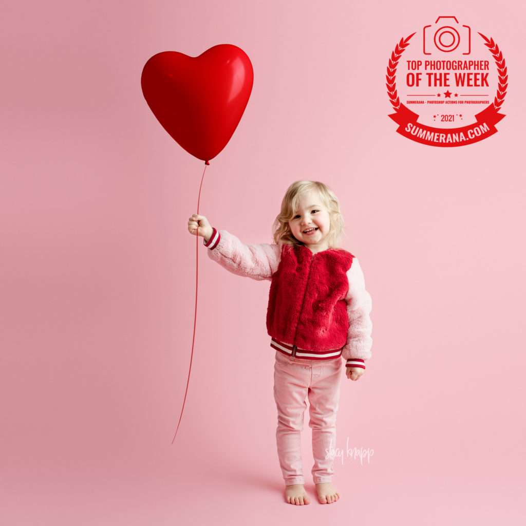 Photo of Maine little girl holding heart balloon for Valentine's Day