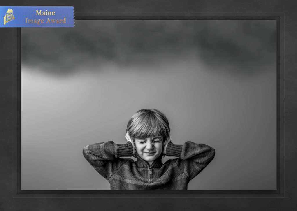 MPPA Maine blue ribbon merit award winning Maine photo of a child boy holding his ears by Stacy Knapp Photography