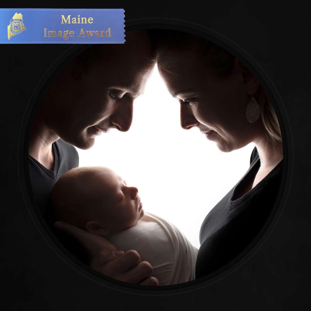 MPPA Maine blue ribbon merit award winning photo of Maine newborn baby boy held by his parents by Stacy Knapp Photography