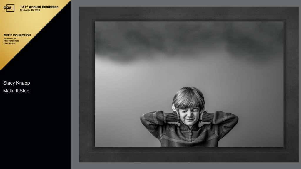 Award winning black and white portrait of a little boy holding his ears with clouds overhead by photographer Stacy Knapp Photography